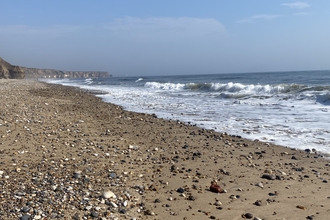 Rocky beach with sea in background