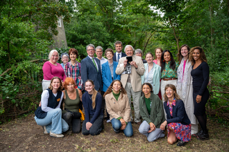 Group of people standing in woodland area