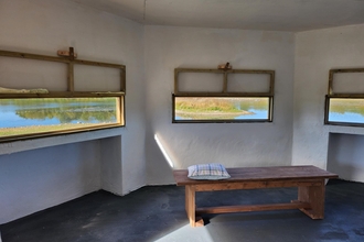 View from inside the rainton meadows hide, includes view through the open windows with the bench seating in the foreground