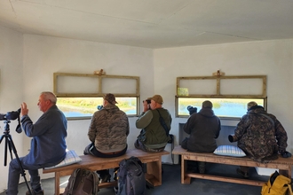 Group of people inside bird hide