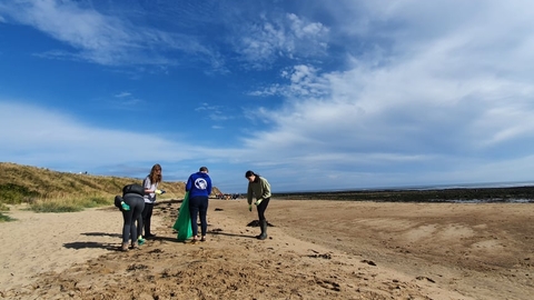 Young people doing beach litter pick