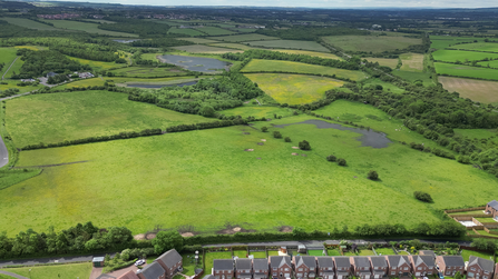 Housing estate backing onto fields on edge of nature reserve