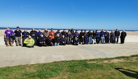 group of people in front of sea wall