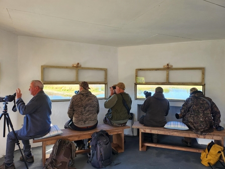 Group of people inside bird hide