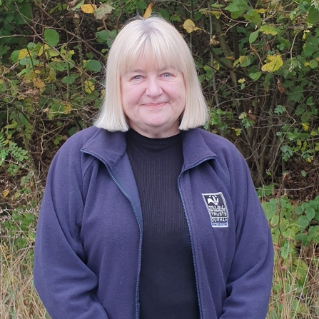 Photo of member of staff, Dawn Tiernan, in front of green tree