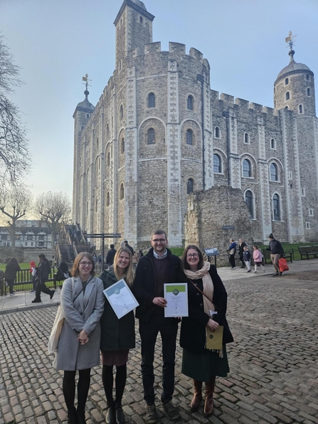 Four people in front of Tower of London