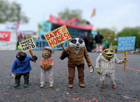 Ratty, Mole, Badger and Toad holding placards asking to save their homes.